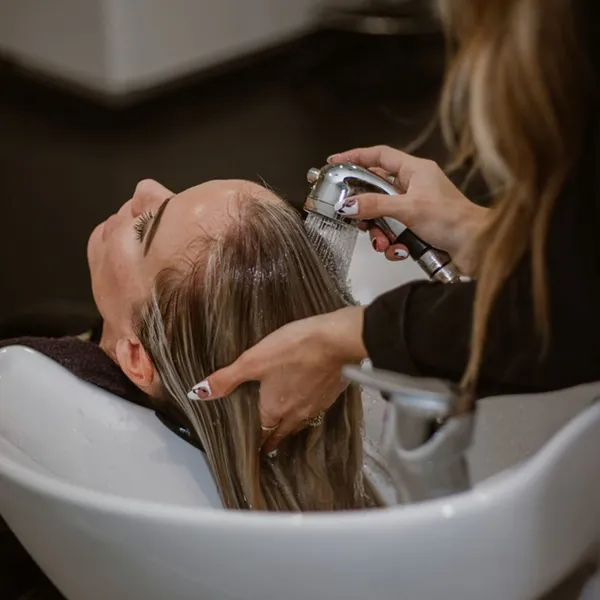 hair being washed after color service