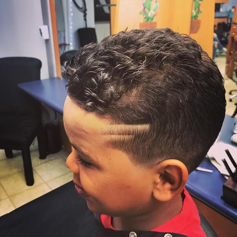 young boy barber haircut with design lines